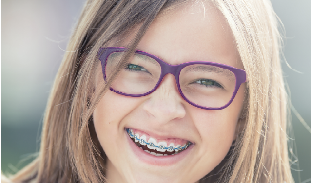 image of a young girl with braces smiling