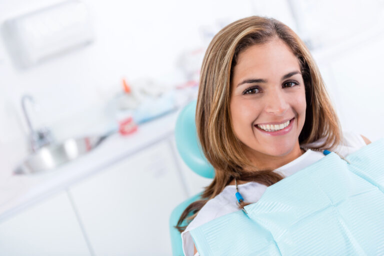Female dental patient smiling for root canal procedure