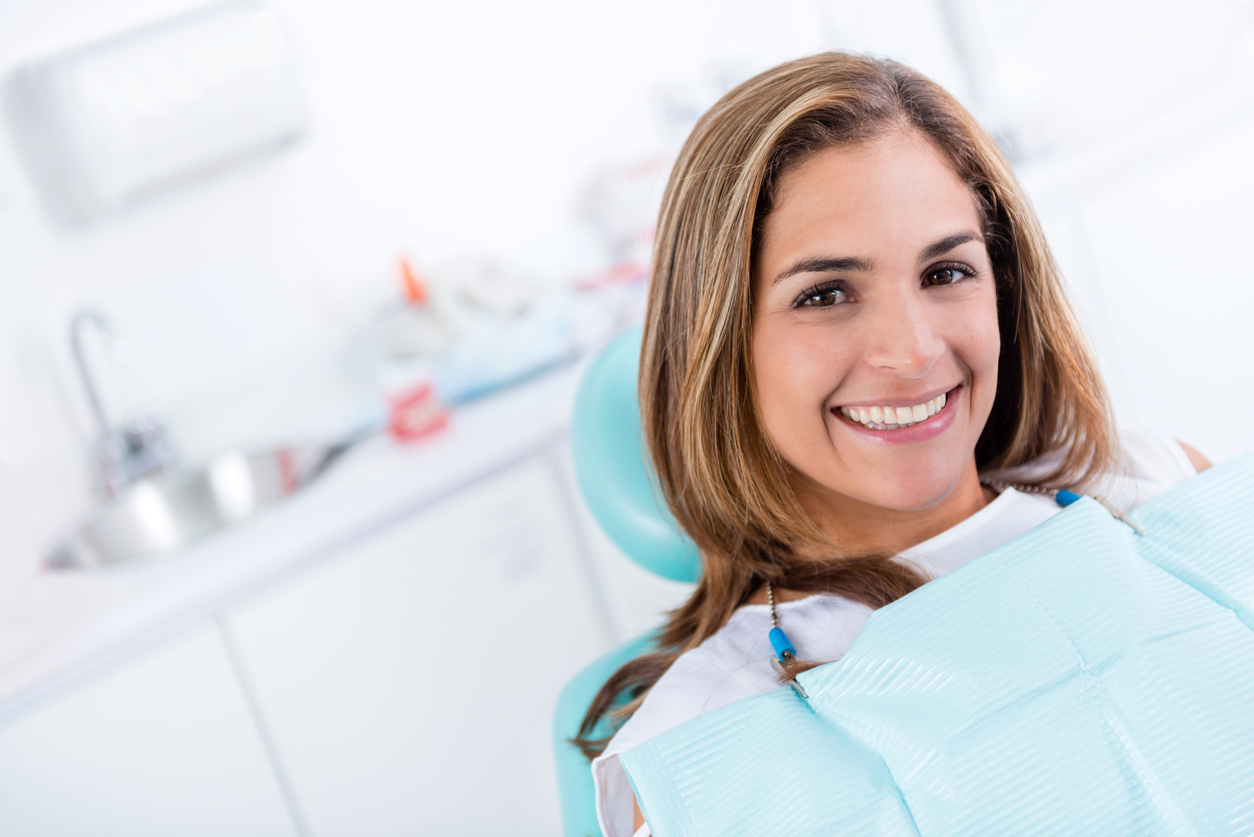 Female dental patient smiling for root canal procedure