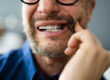Man with a toothache pressing on cheek